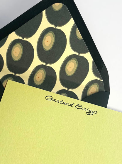 Close-up of Martini Olive stationery showing personalized script and the envelope’s green olive-patterned liner.