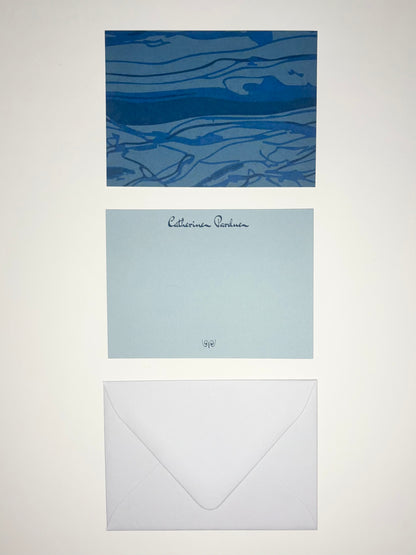 Thrust Belt stationery set showing a blue geological-patterned back, pale blue personalized front, and white envelope.