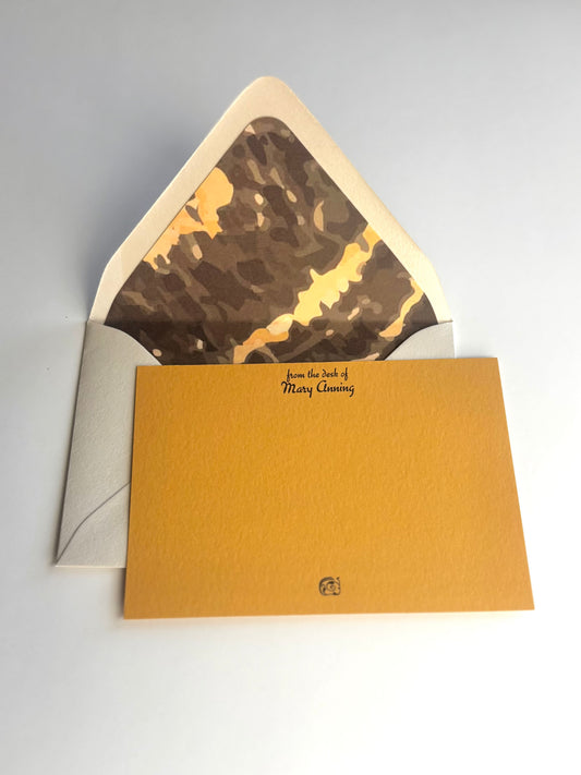 Gneiss personalized golden yellow notecard with an open cream envelope lined in a brown and gold gneiss pattern.