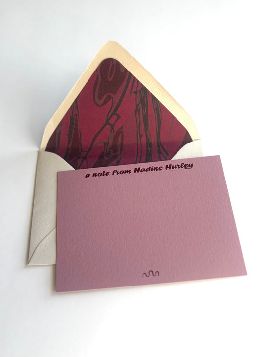 Meandering River personalized dusty pink notecard with an open cream envelope lined in a deep wine river pattern.