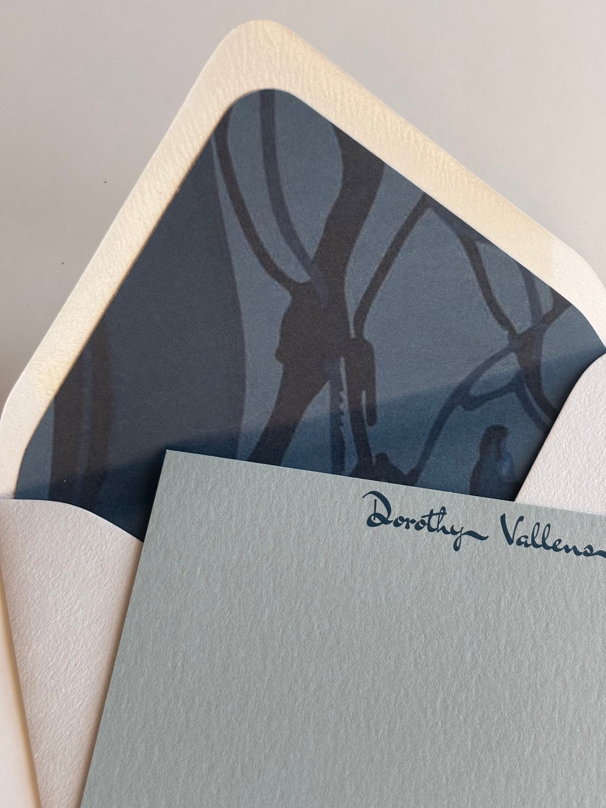 Close-up of The Fall Line stationery showing personalized script and the envelope’s blue map-patterned liner.