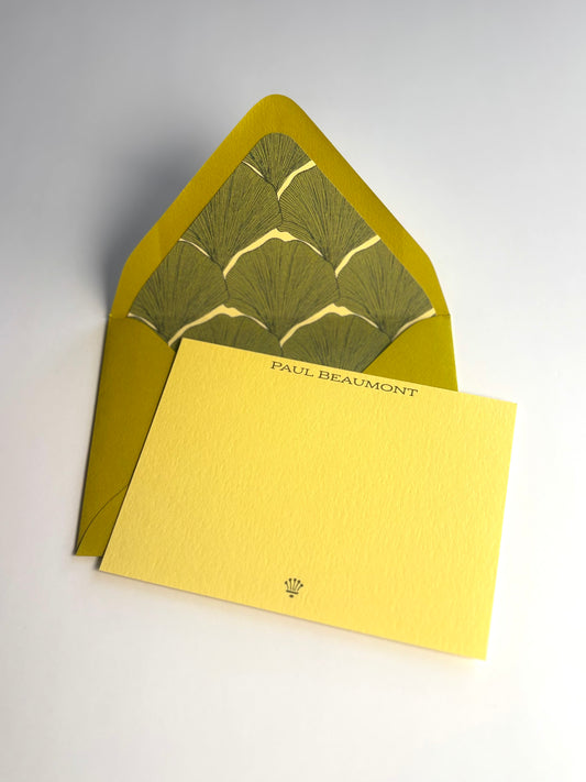 Living Fossil personalized soft gold notecard with an open chartreuse envelope lined in a green ginkgo leaf pattern.