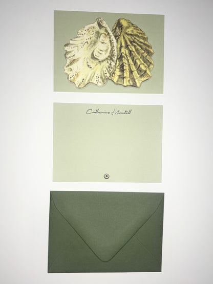 Oyster Shells stationery set showing a shell-illustrated back, personalized pale green front, and dark green envelope.
