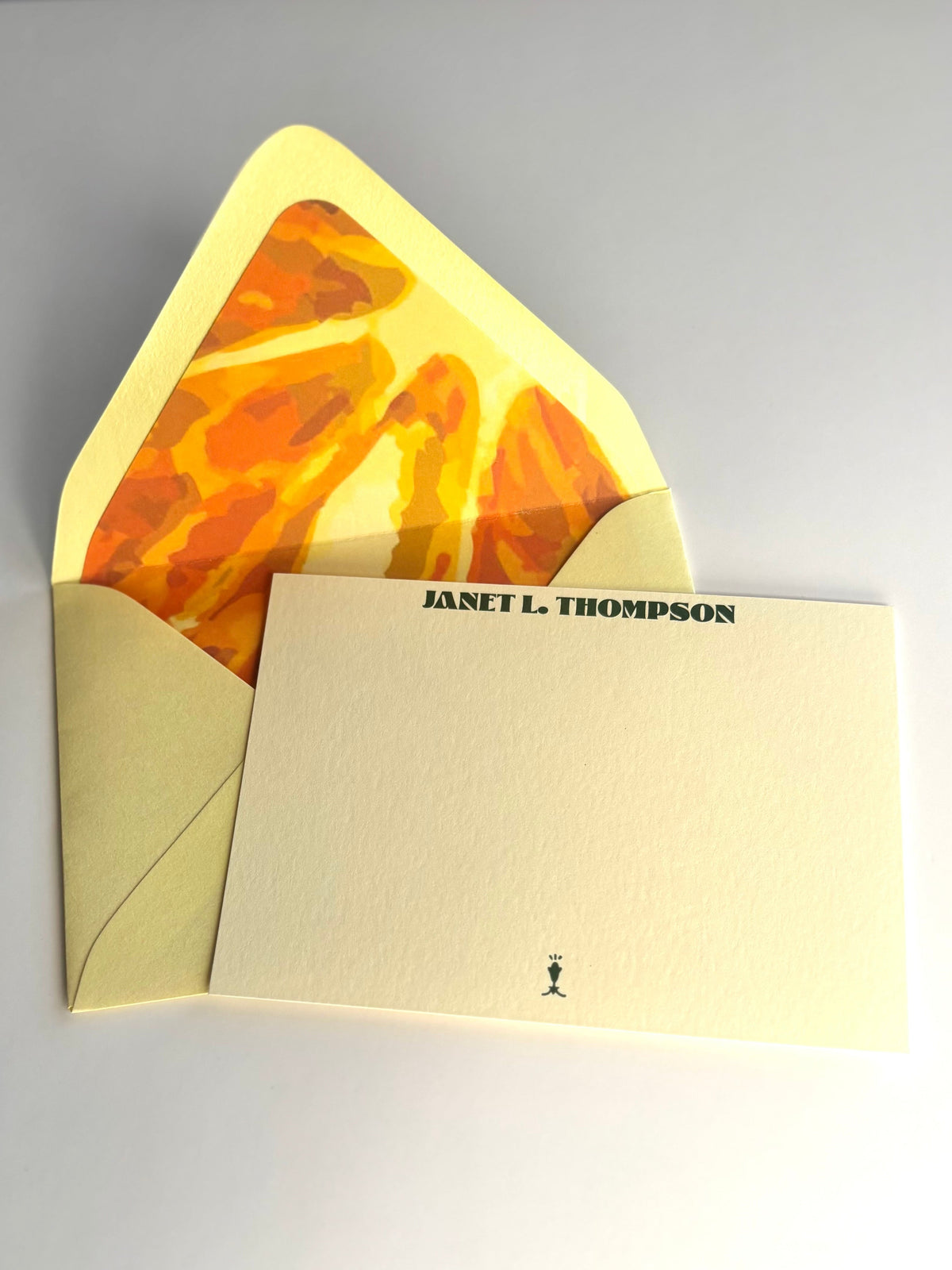 Orange You Glad personalized cream notecard with an open pale yellow envelope lined in an orange slice design.