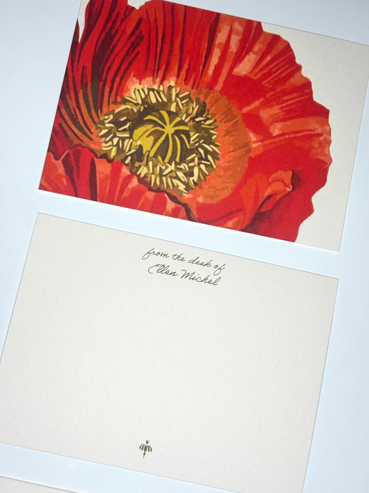 Close-up of Full Blossom stationery showing an oversized red poppy illustration and a personalized blush writing side.