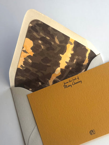 Close-up of Gneiss stationery showing personalized script and the envelope's brown and gold gneiss liner.