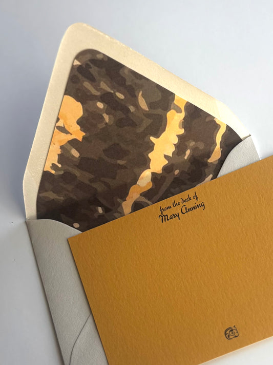 Close-up of Gneiss stationery showing personalized script and the envelope's brown and gold gneiss liner.